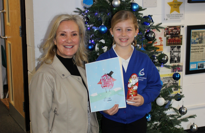 Caroline Dinenage with the winner of her 2024 Christmas card competition, Emelia